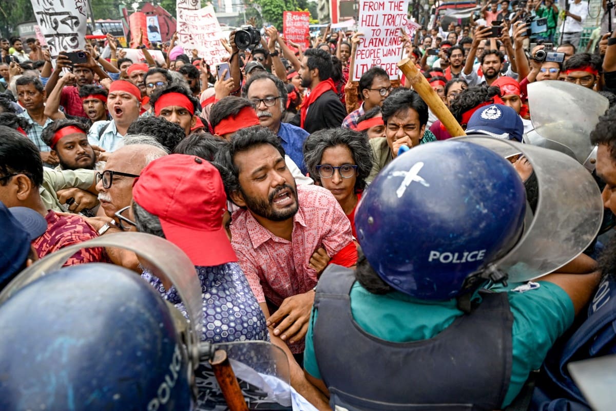 AFP__20240730__367E4GP__v1__Preview__BangladeshUnrestStudents Channel 13 cameraman tackled to ground by riot police Feb 19 protest.