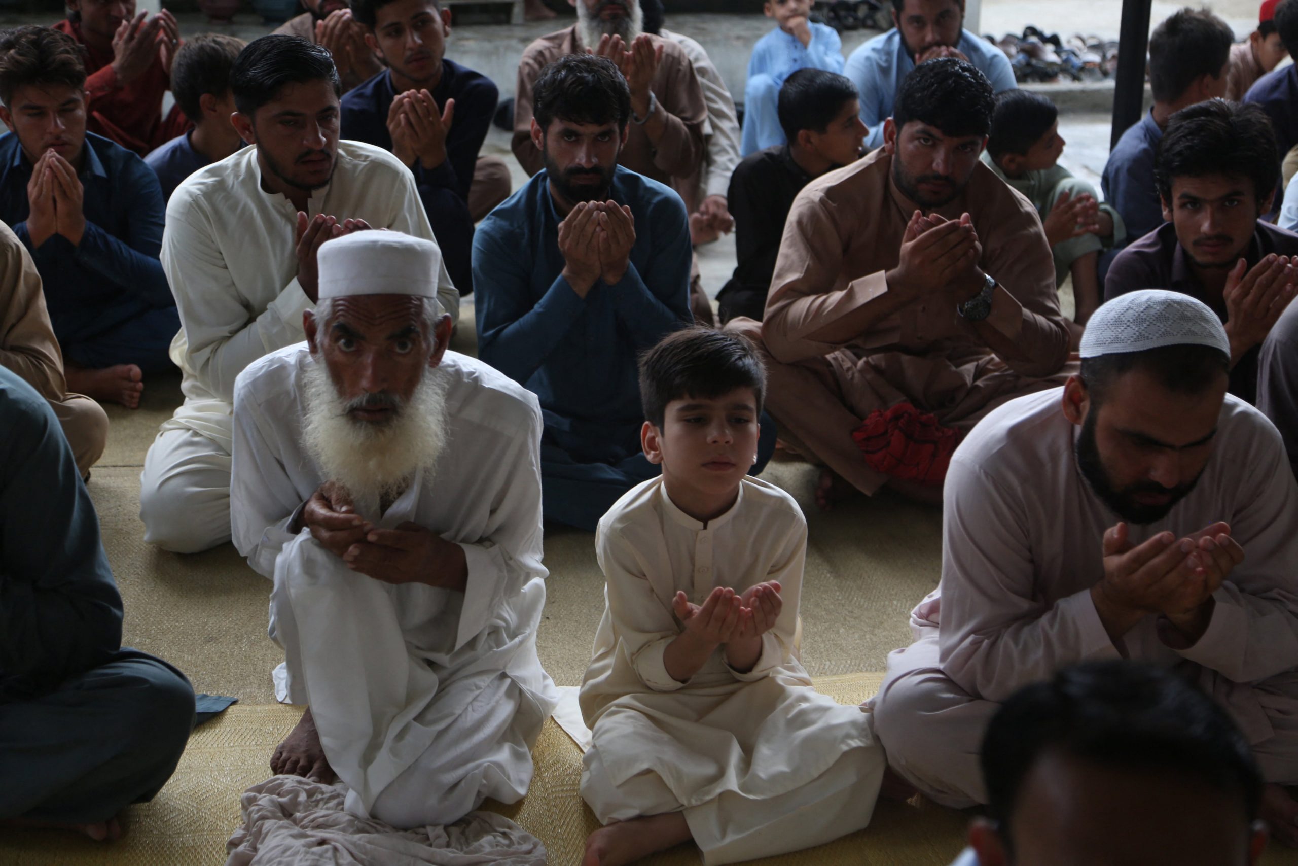000_32E483R Afghan refugees offer Eid al-Adha prayers Abdul MAJEED AFP-min