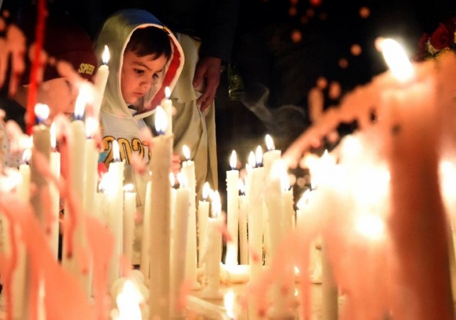 Pakistani civil society activists light candles in Quetta on December 16, 2015, on the first anniversary of attack on Army Public School Peshawar. Pakistan's leader, speaking beneath portraits of children killed by Taliban bullets, called for vengeance as the country marked the first anniversary of a school massacre that killed 151 people in its worst-ever extremist attack. AFP PHOTO / Banaras KHAN / AFP PHOTO / BANARAS KHAN